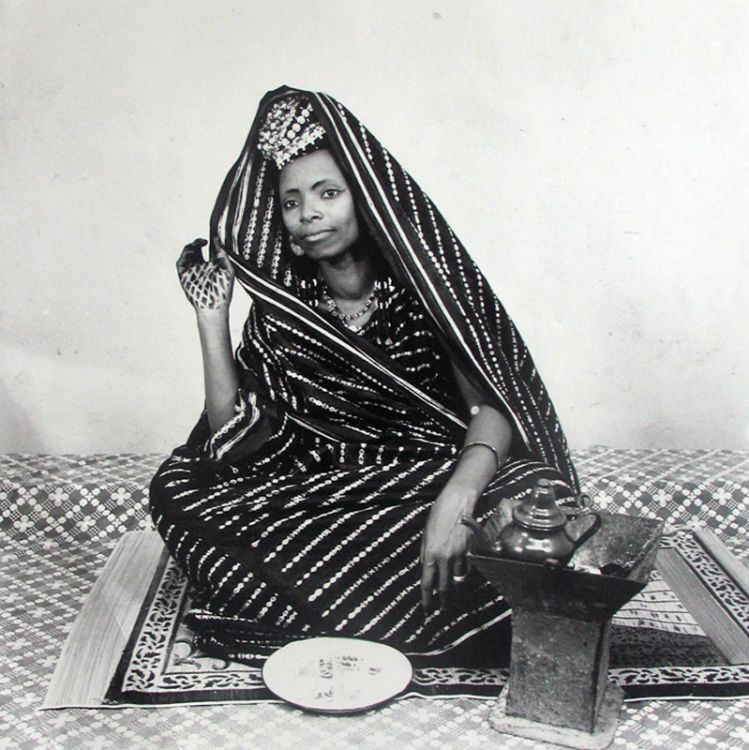 Black and white photograph by Malick Sidibé of a woman wearing indigo-dyed fabric, Mali, 1960s