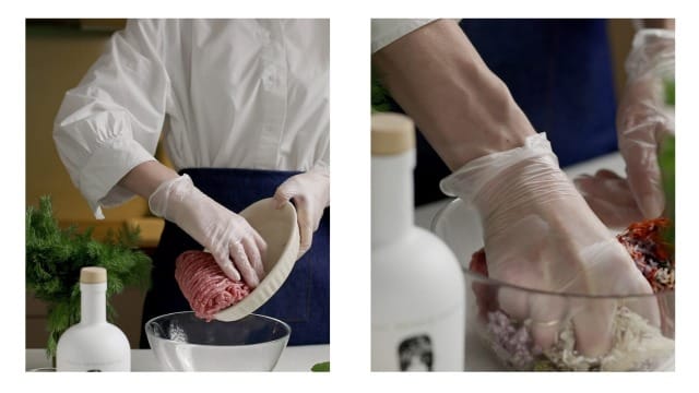 A cook adding ground meat to a bowl with PJ Kabos Extra Virgin Olive Oil on the table next to her.