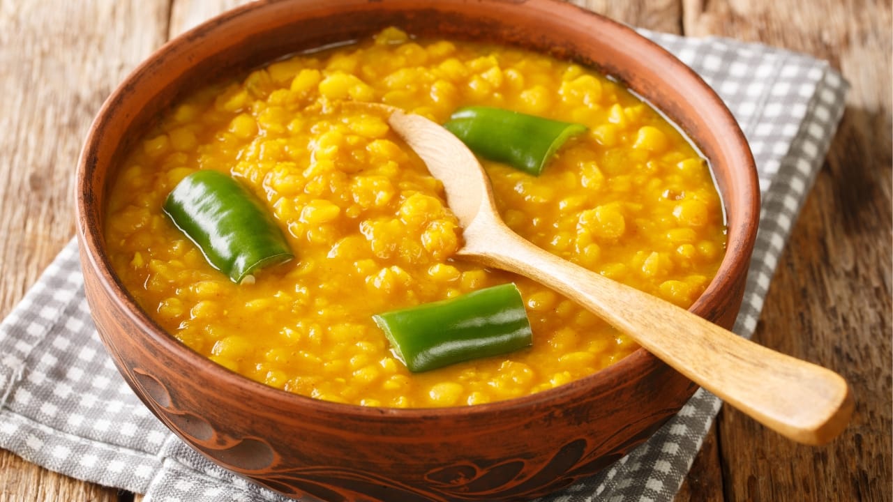 A bowl of Ethiopian Yellow Split Pea Soup, Kik Alicha, featuring the gentle flavors of turmeric and ginger.