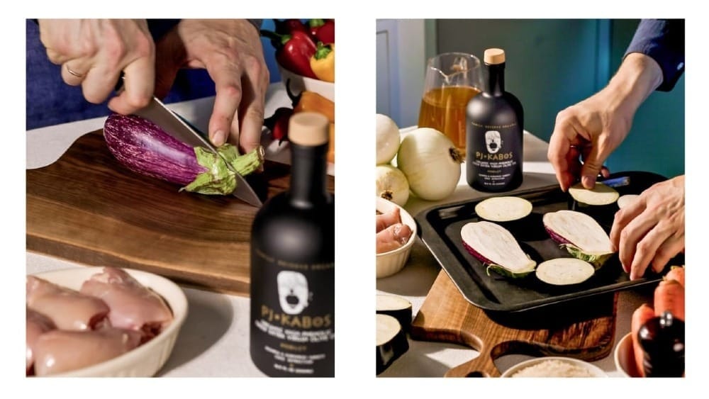 Eggplants being cut and put on a roasting pan.  PJ Kabos Family Reserve Organic Robust Extra Virgin Olive Oil is shown.