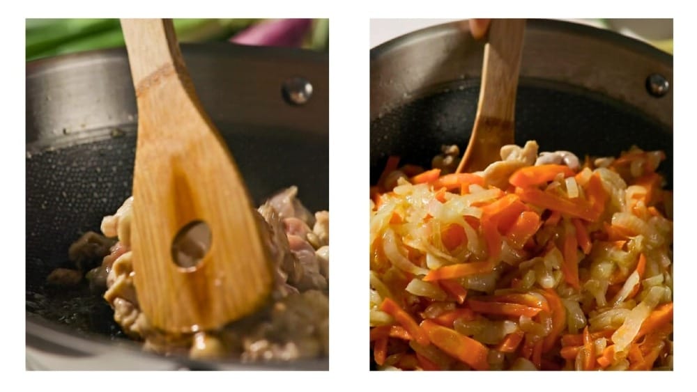 Chicken, onions, and carrots simmering in olive oil in a skillet—ingredients are golden and glossy, mid-cooking.