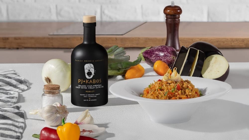 Chicken pilaf with vegetables and PJ Kabos olive oil, surrounded by fresh eggplant, garlic, peppers, and onion.