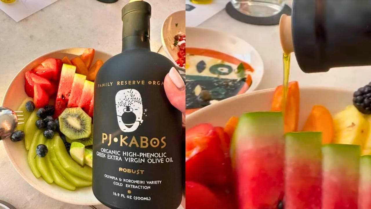 PJ Kabos Family Reserve Organic Robust black bottle with fresh fruit plate of kiwi, berries, apricots, pineapple, apple, and watermelon.