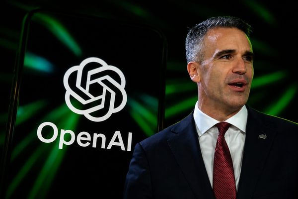 South Australian Premier Peter Malinauskas in front of a screen showing the OpenAI logo