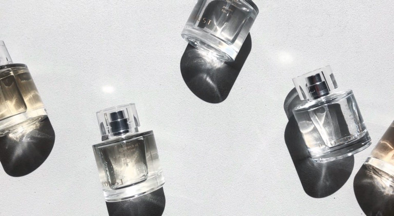 PROUST custom perfume bottles arranged in sunlight with long shadows