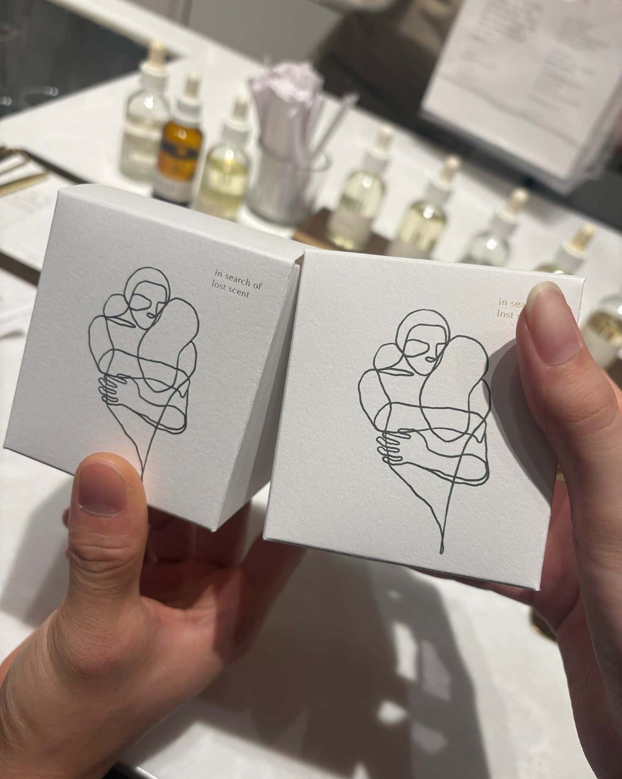 PROUST gift boxes beside fragrance materials