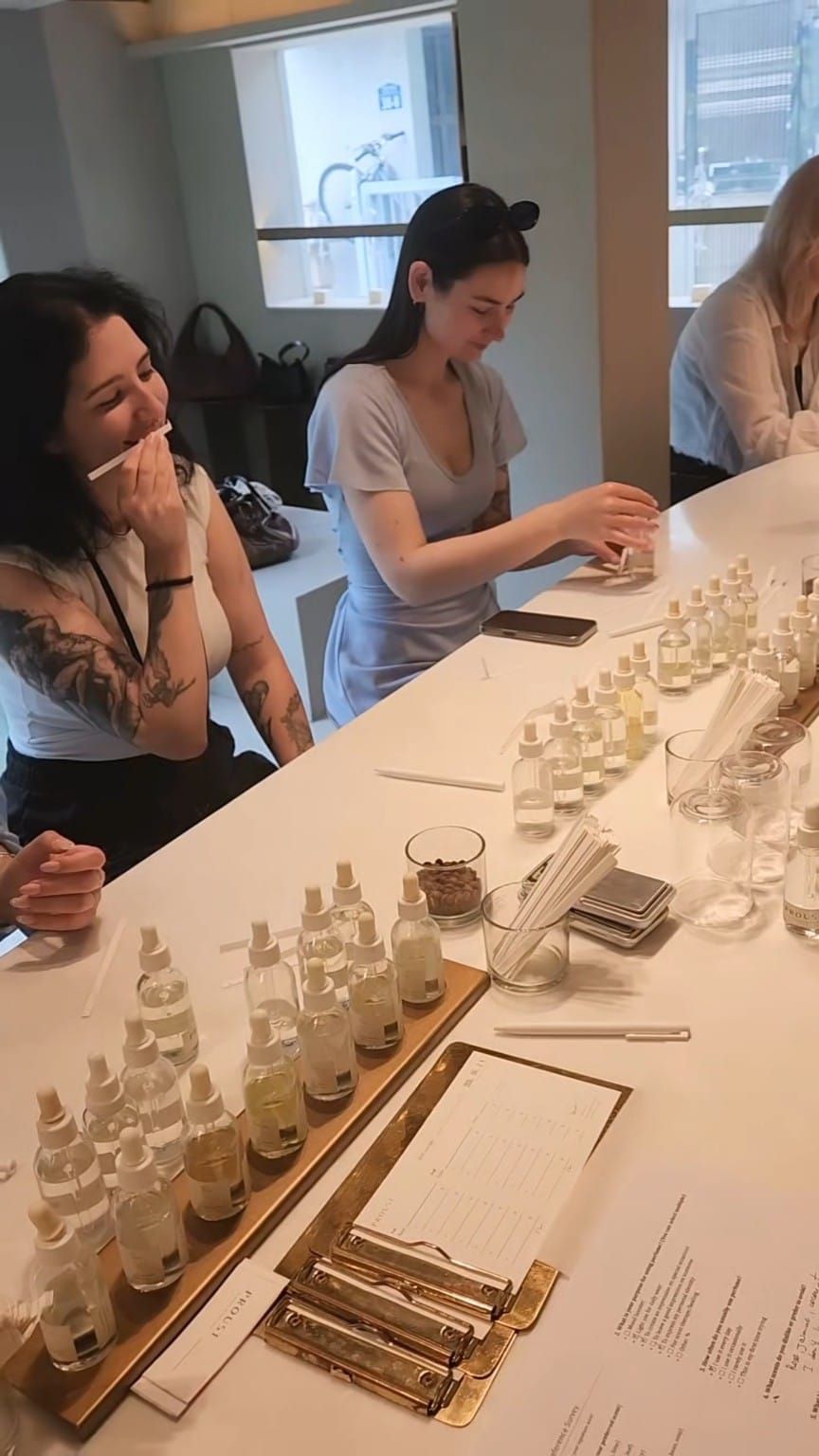 Guests smelling fragrance strips and exploring scent materials at PROUST