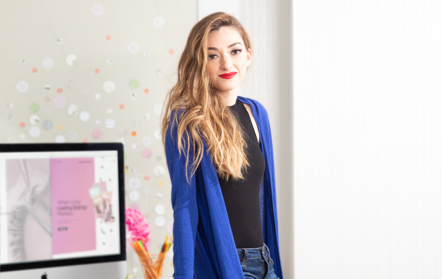 Shannon Fitzgerald sitting on desk alongside computer