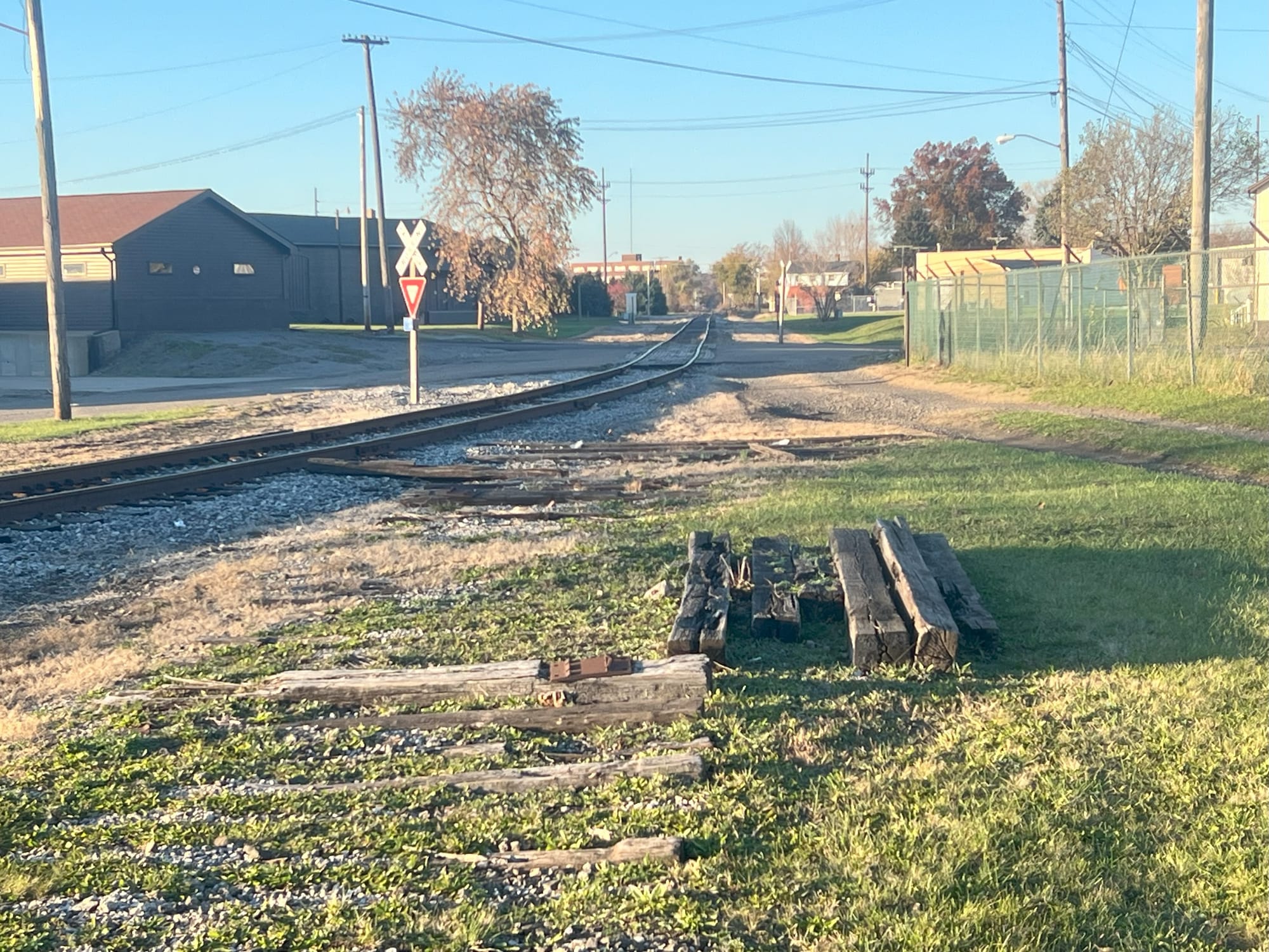 Rail Right of Way with tracks removed looking North where still active tracks lie.