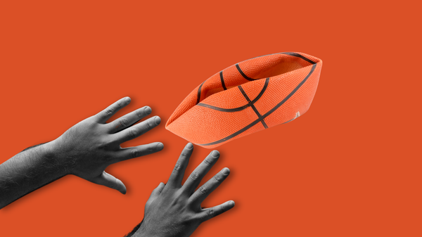 Two outstretched hands meet a deflated and crushed basketball