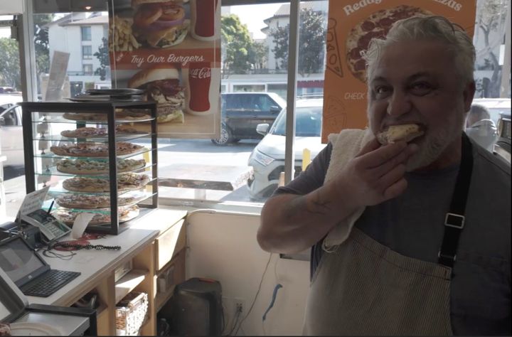 Nando, shown here eating pizza, came to America with big dreams, but no money. He's been an actor, but his favorite role is pizza maker for his popular restaurant, The Good Pizza.