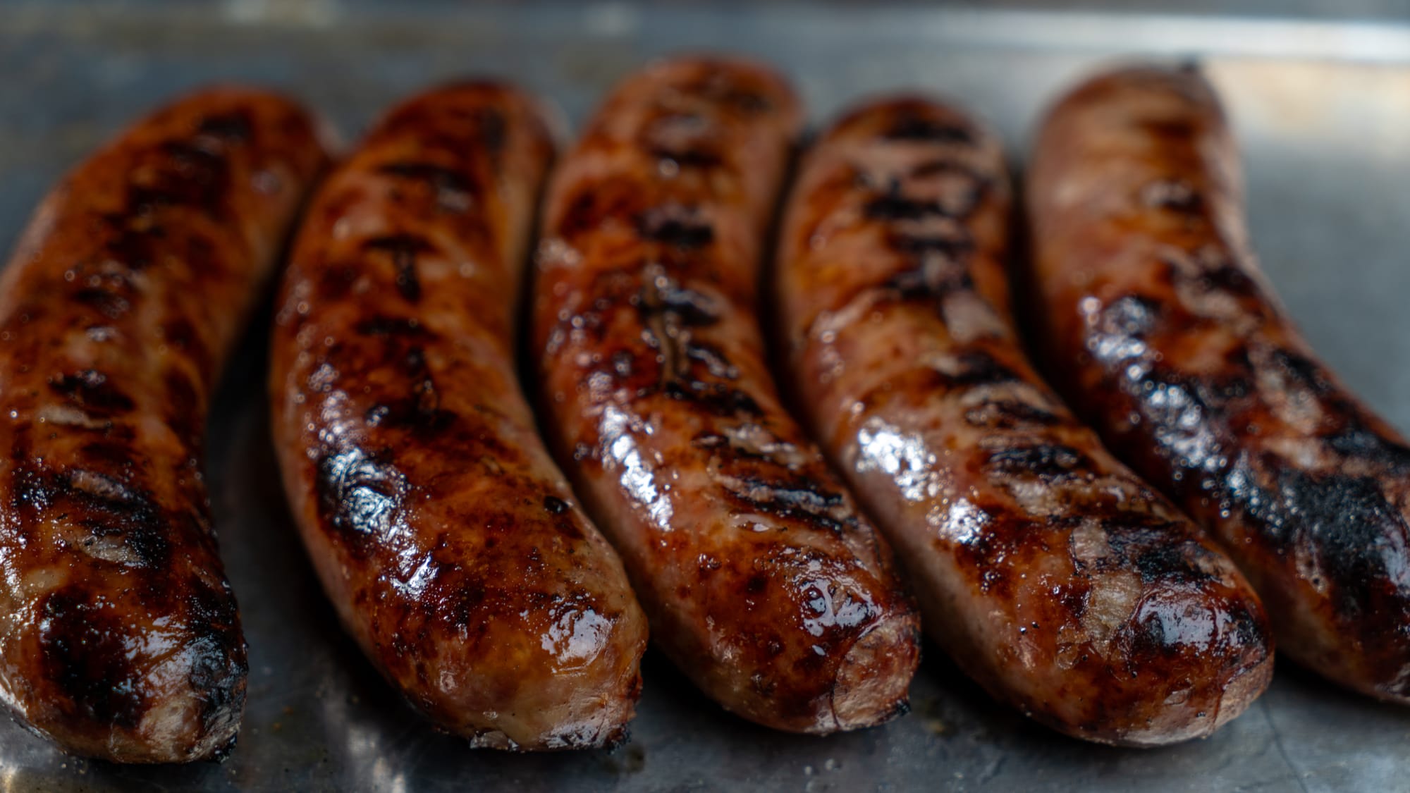 Featured: Beer Braised and Grilled Brats with Onions