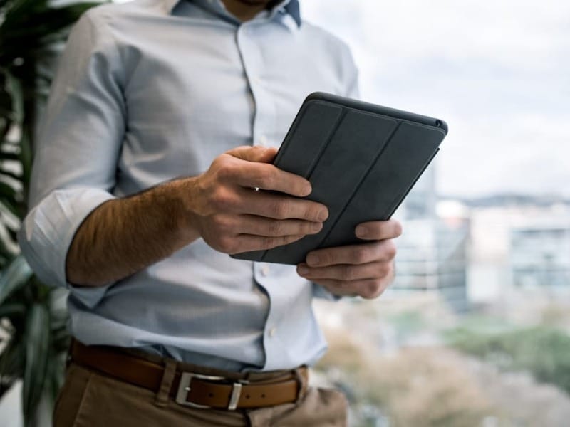 person holding black smart cover during daytime