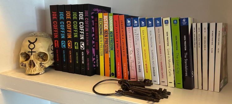 A shelf full of the author's books