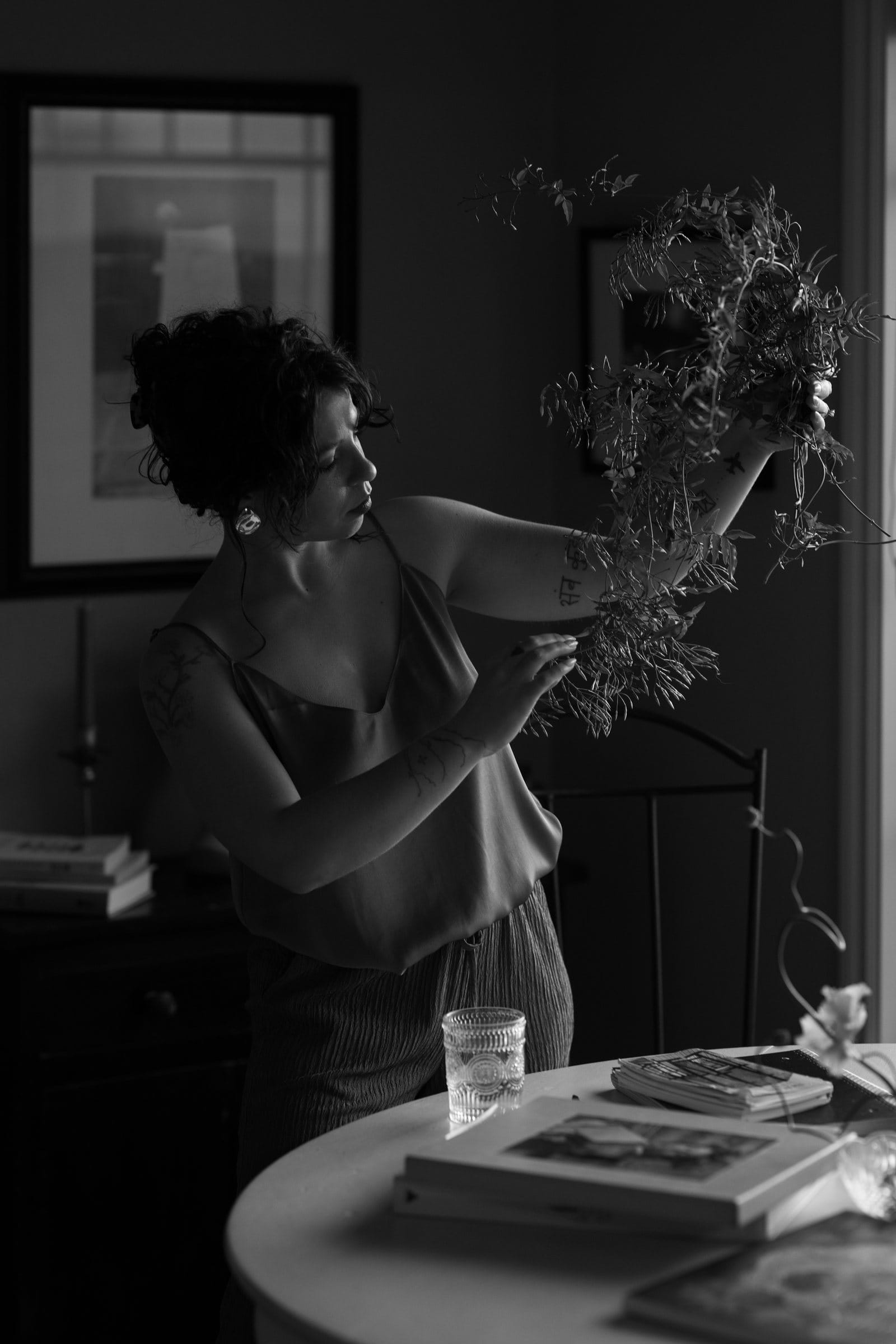 Black and white photo of a florist arranging dried stems