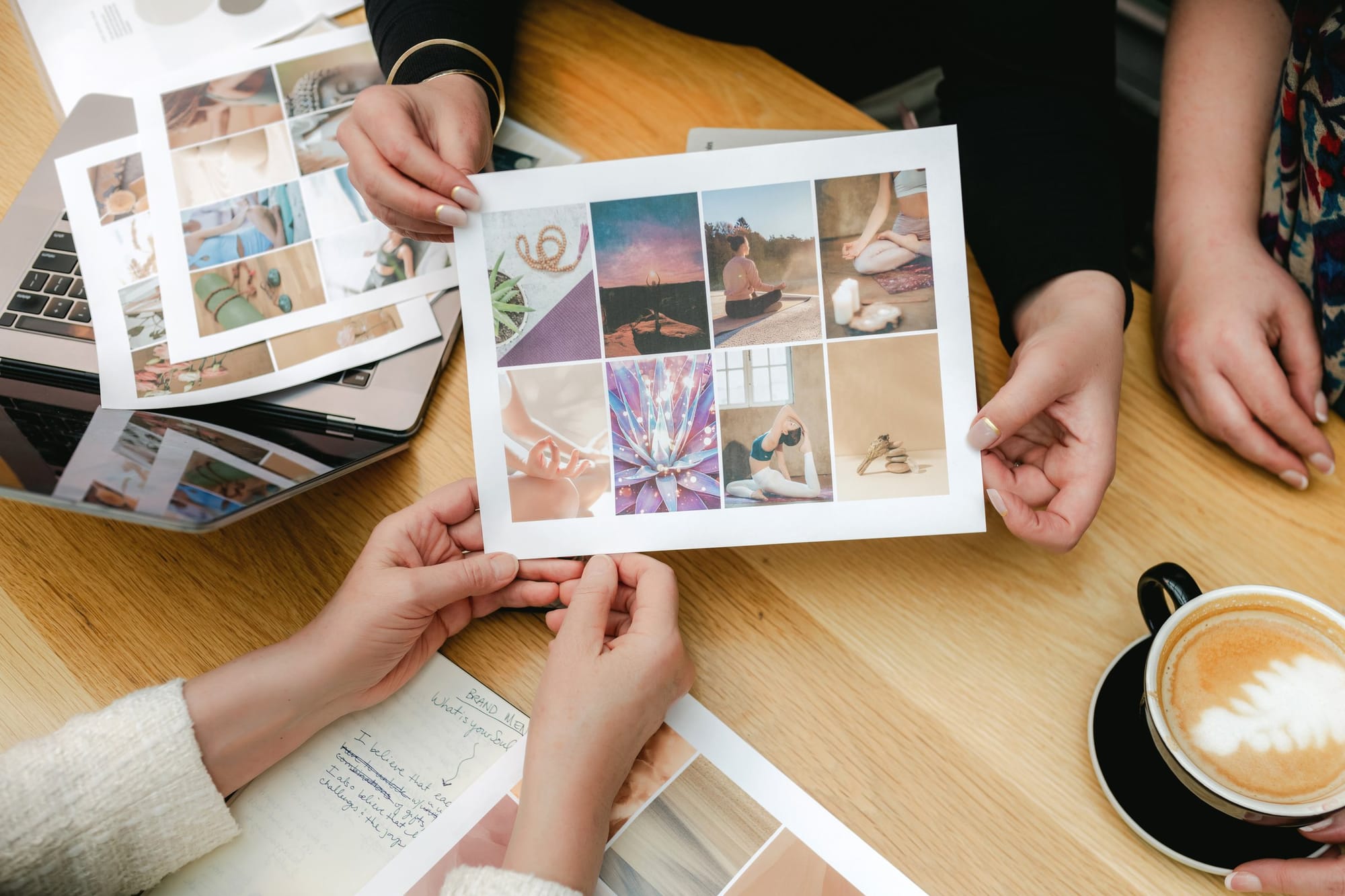 Hands passing mood boards across a café table during a brand planning session