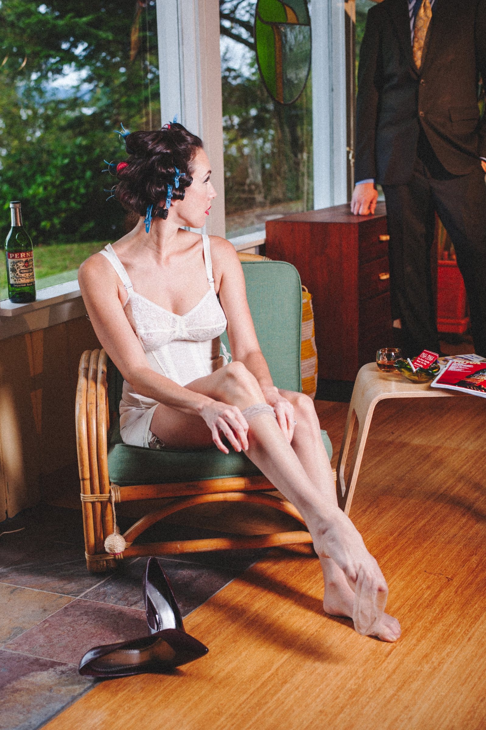 Playful 1950s housewife editorial in a mid-century living room