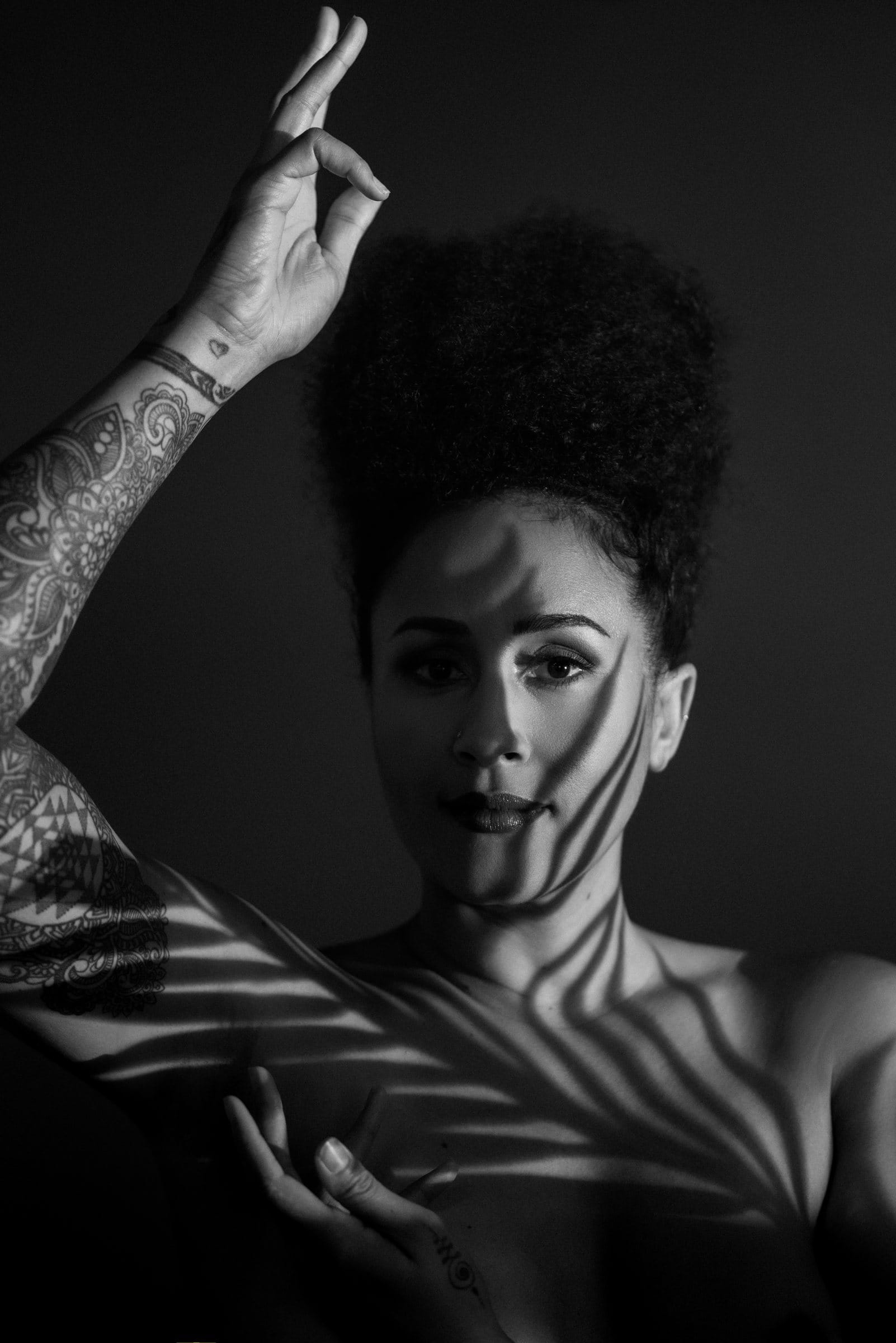 Black and white editorial portrait with leaf shadows