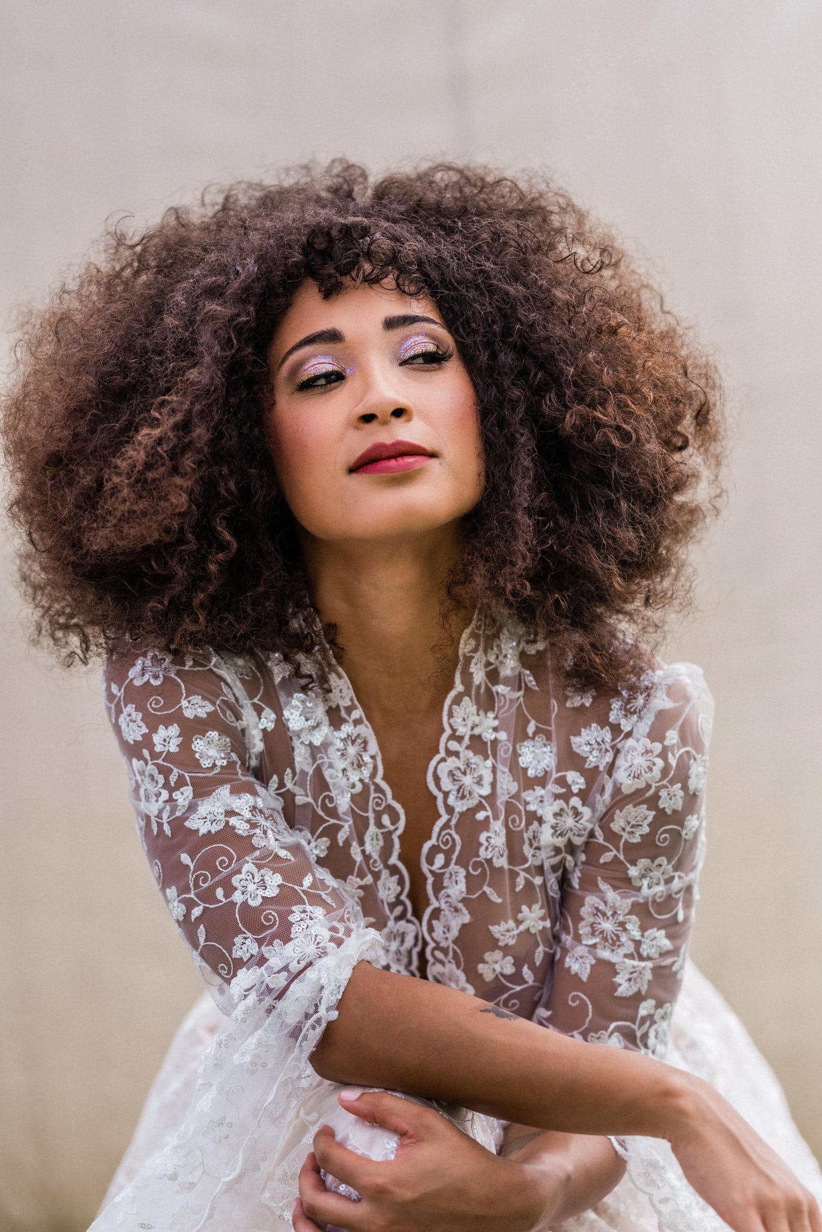 Woman with voluminous curls in white lace