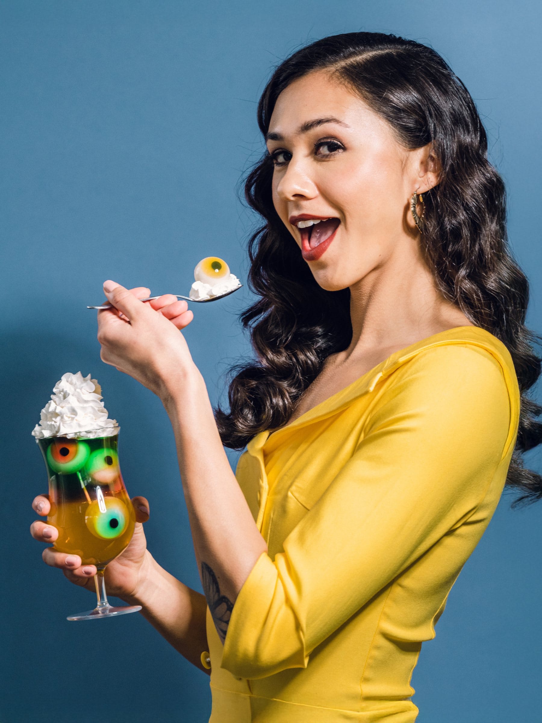 Retro editorial portrait with an eyeball sundae against blue