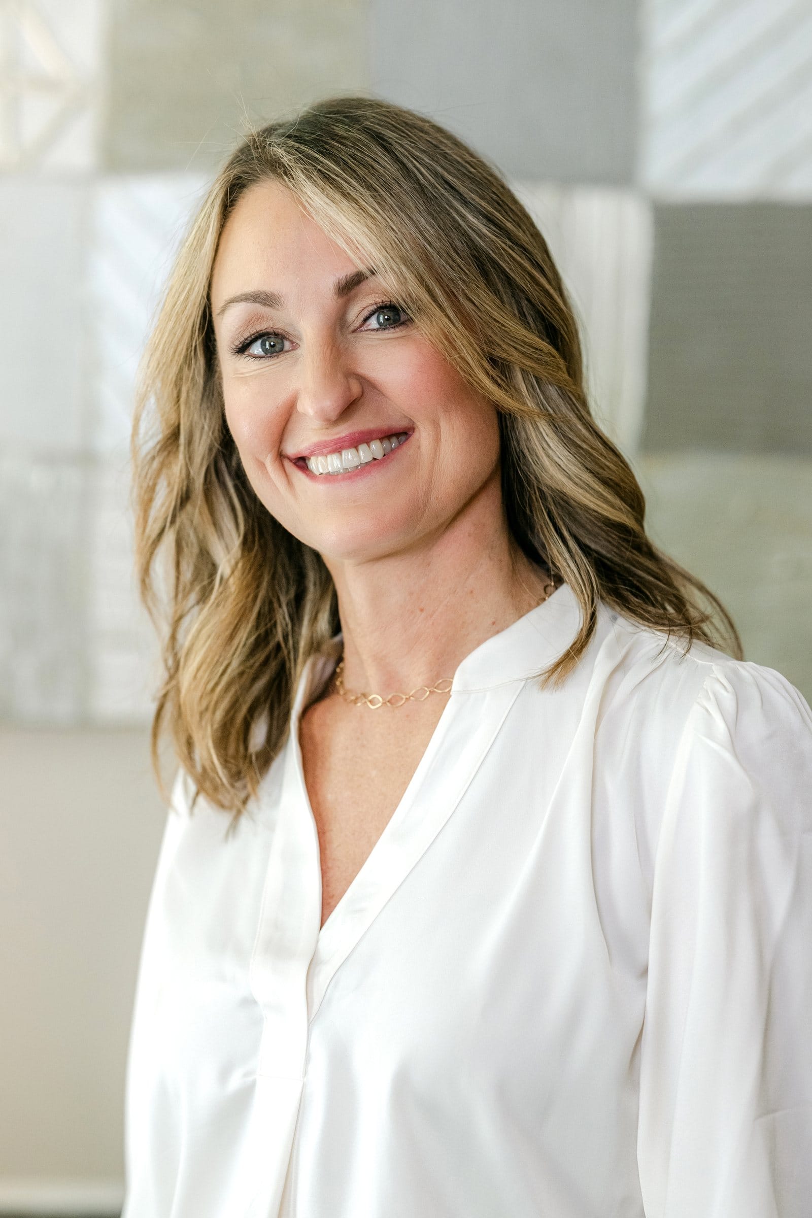 Woman in a white blouse with a soft smile