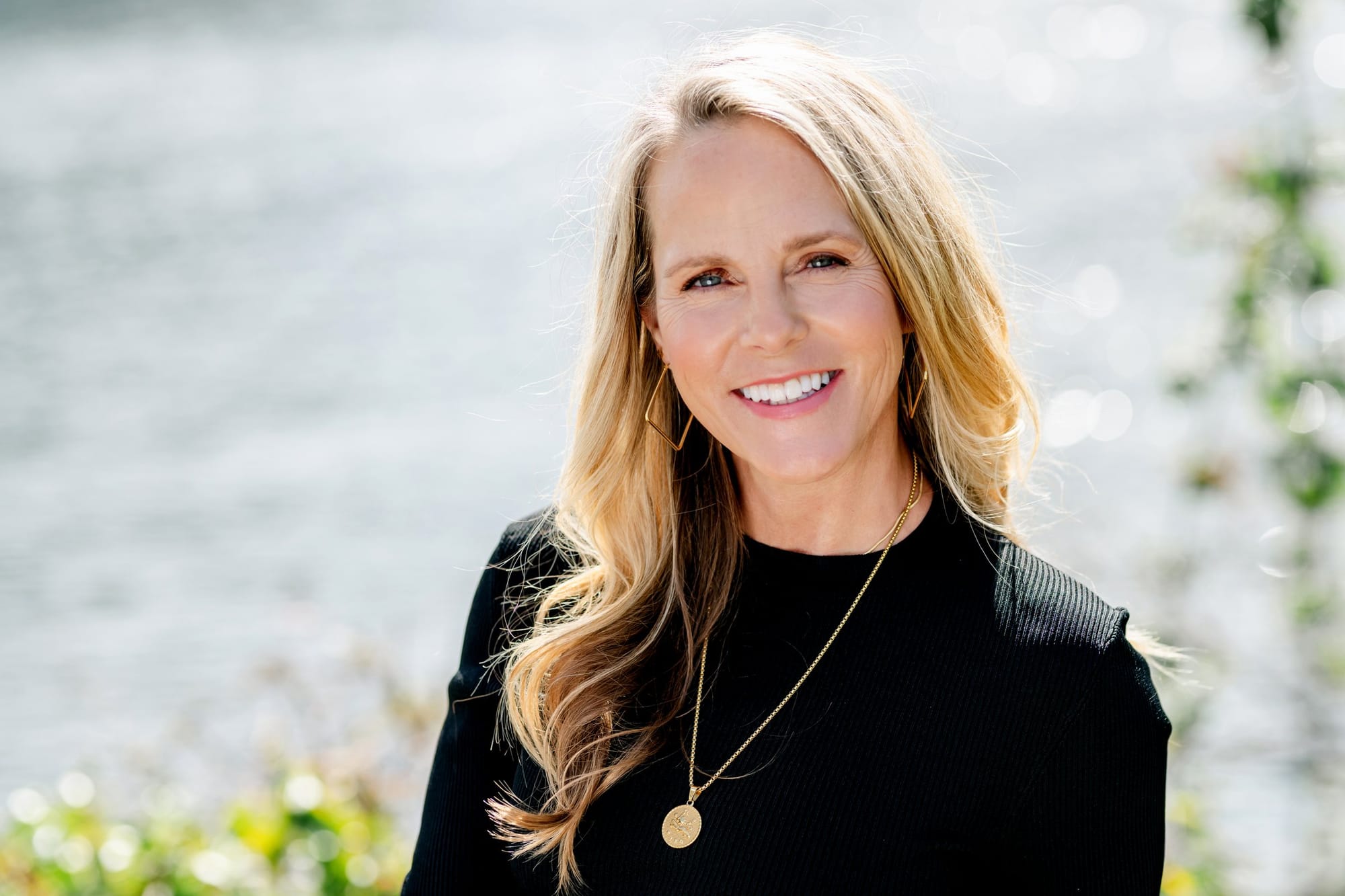 Smiling woman on a sunlit waterfront