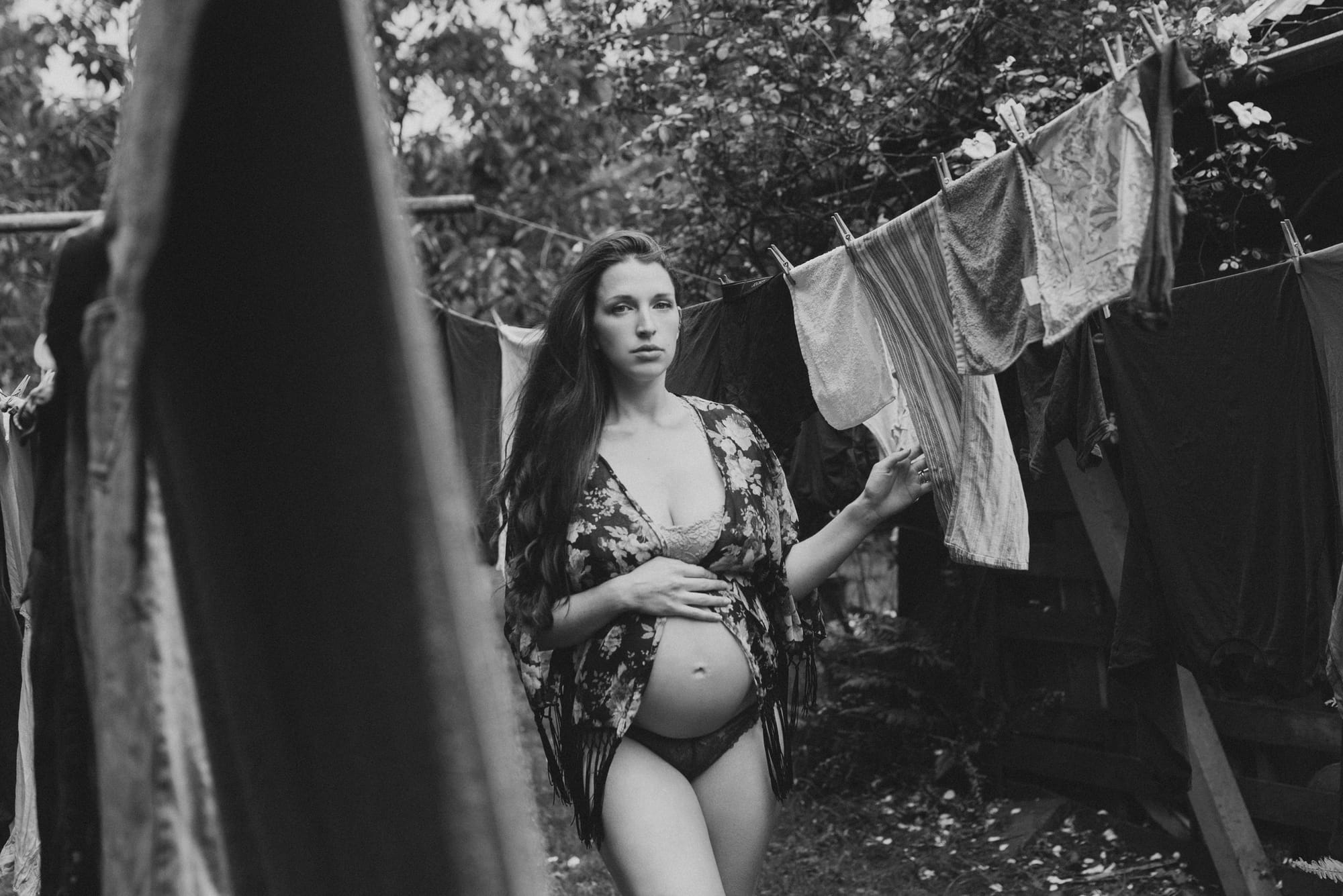 Black and white maternity portrait by a clothesline