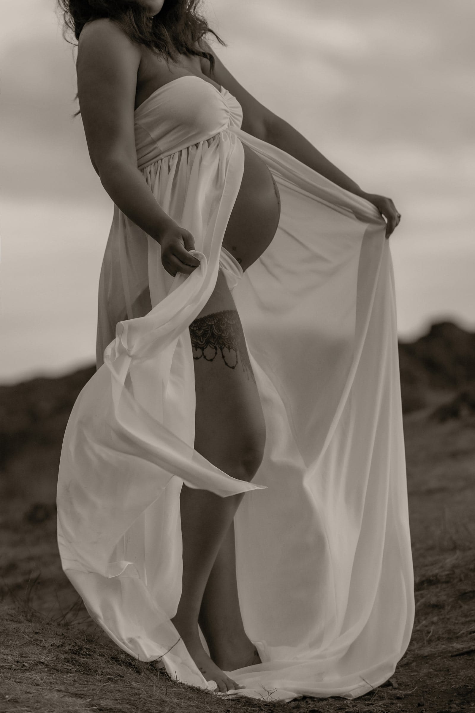 Sepia maternity portrait in a flowing gown