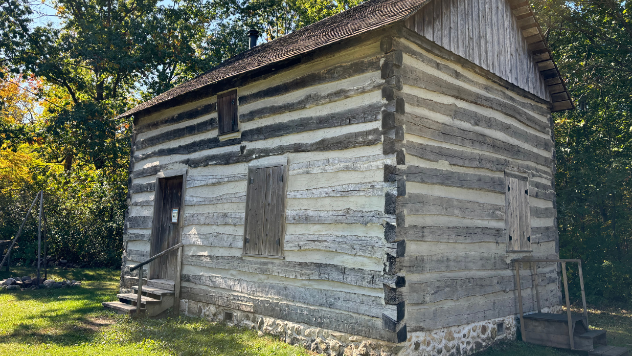 Historic log building at the Richfield Historical Park in Wisconsin with The Tower Heritage Center