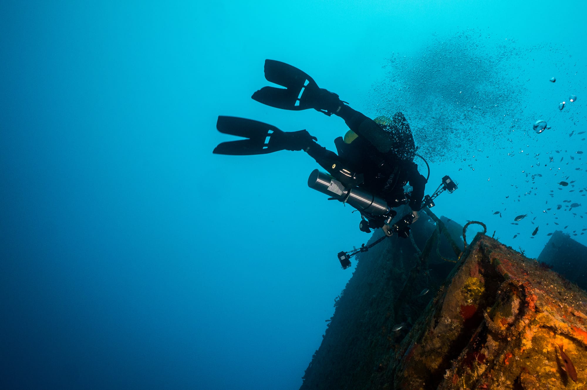 technical scuba diving photographer using split fins on a wreck