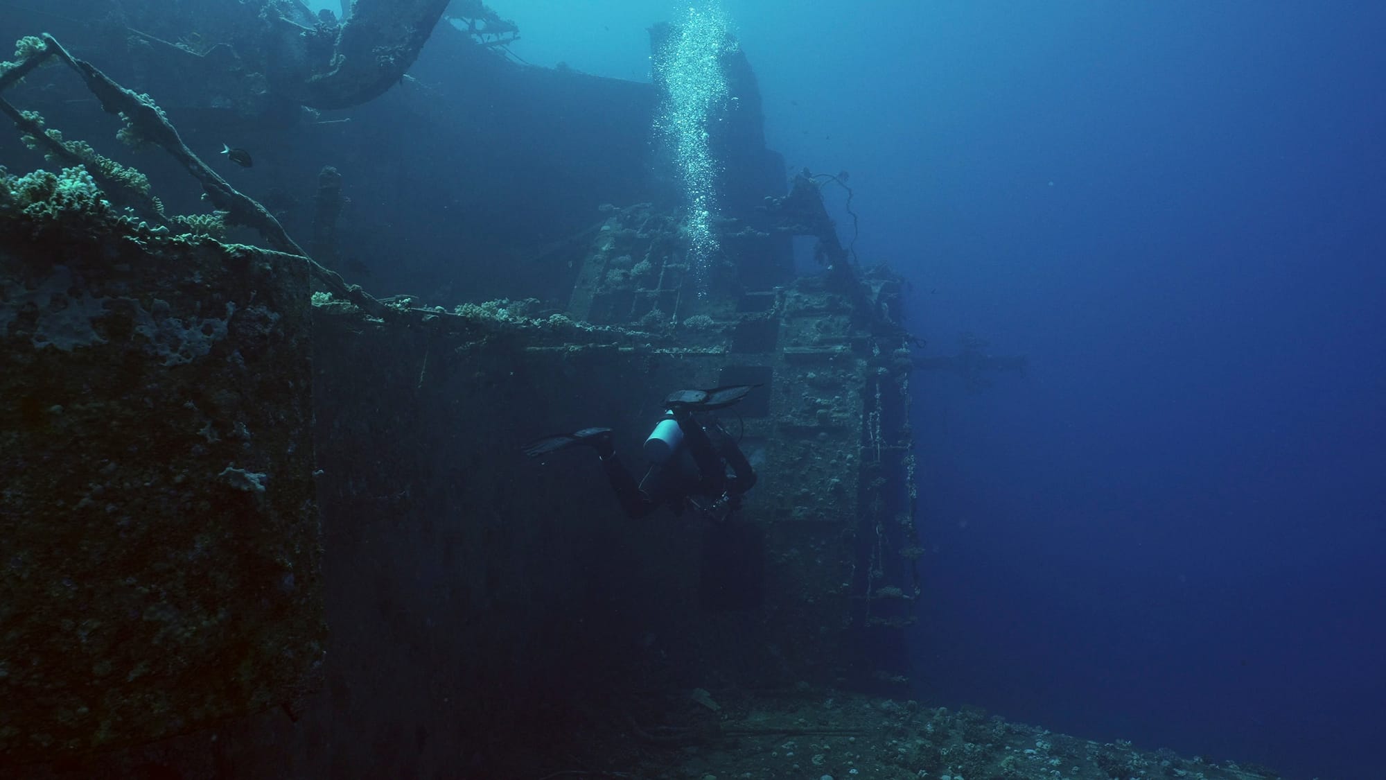 Scuba diver next to the ferry Salem Express shipwreck in the red sea in Egypt.