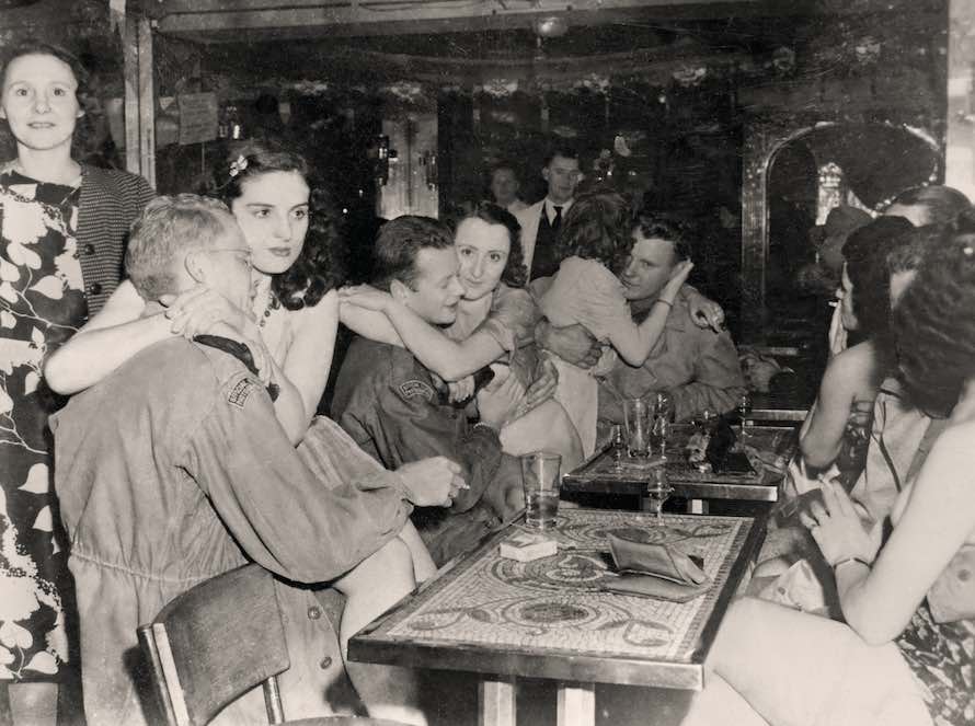 Brothel in Saint-Germain-en-Laye. The photo was taken by a Ghost Army officer, but the men in the photo are wearing patches identifying them as 