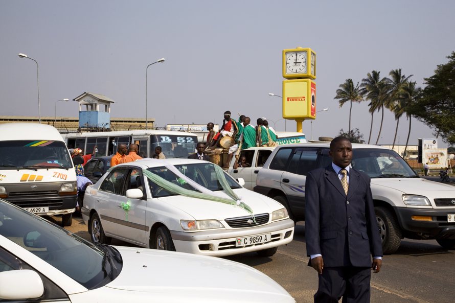 Drummers on their way to perform at a wedding in the center of Bujumbura on a Saturday afternoon. The colors red, green, and white are symbols for blood, hope and peace.