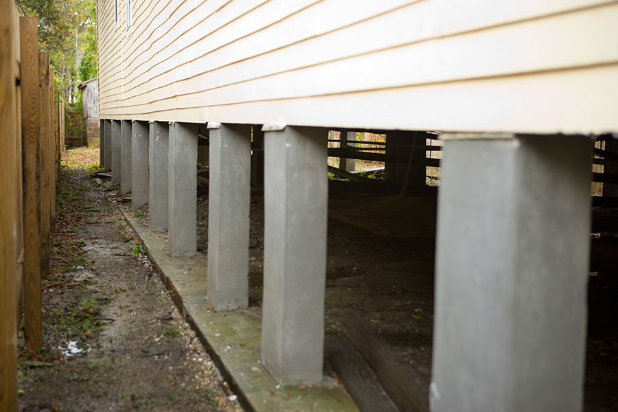 The homeowner raised the home last March. In many areas—including this part of Hollygrove—insurance companies or the city of New Orleans require homeowners who are rebuilding to raise their foundations because of flood risks. Plenty of people already gave up their homes because of the prohibitive cost of raising them. Often a homeowner can afford to rebuild or raise, but can’t pay for both. <br /><br />
The process can cost up to $40,000 and involves building towers of six-by-six beams—stacked “like a huge Jenga game,” says Cambria—that prop up steel beams running the length and width under the house. “I’ve definitely seen houses in the process of being raised that have collapsed,” Cambria tells us. The pylons the house then stands on are made from rebar-enforced concrete.<br /><br />
Though the preparation can take a long time, the actual raising is done with hydraulic machines and happens in about an hour.
