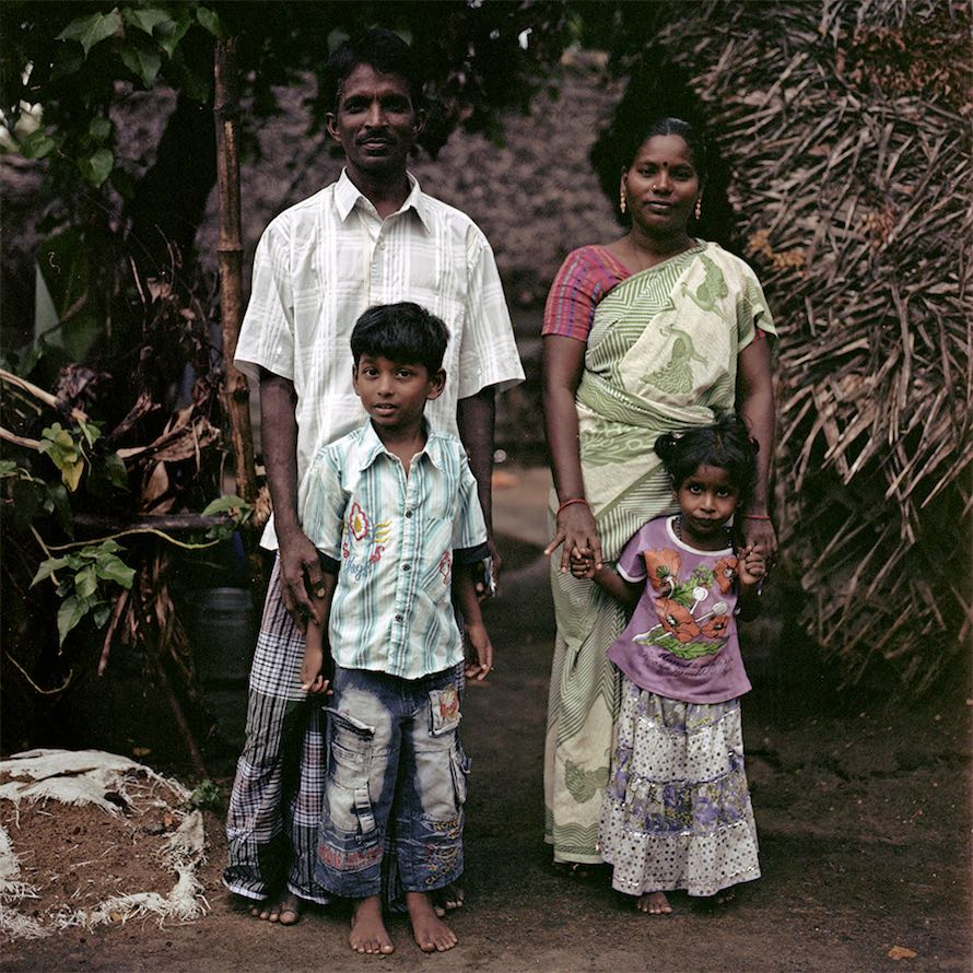 Jagada Guru, whose Kothi name is Arundhati, poses with his wife and children outside of their house in Devanipattinam. September 2014.