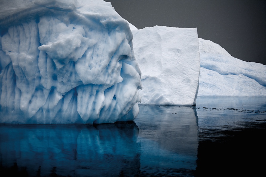 “‘Bergy bits’ are small icebergs that may be no larger than a house. These three bergy bits, jammed like parked cars next to each other, display the variety of shapes and personality that an iceberg can possess.” Bergy Bits in Errera Channel, Antarctic Peninsula, December 2007.