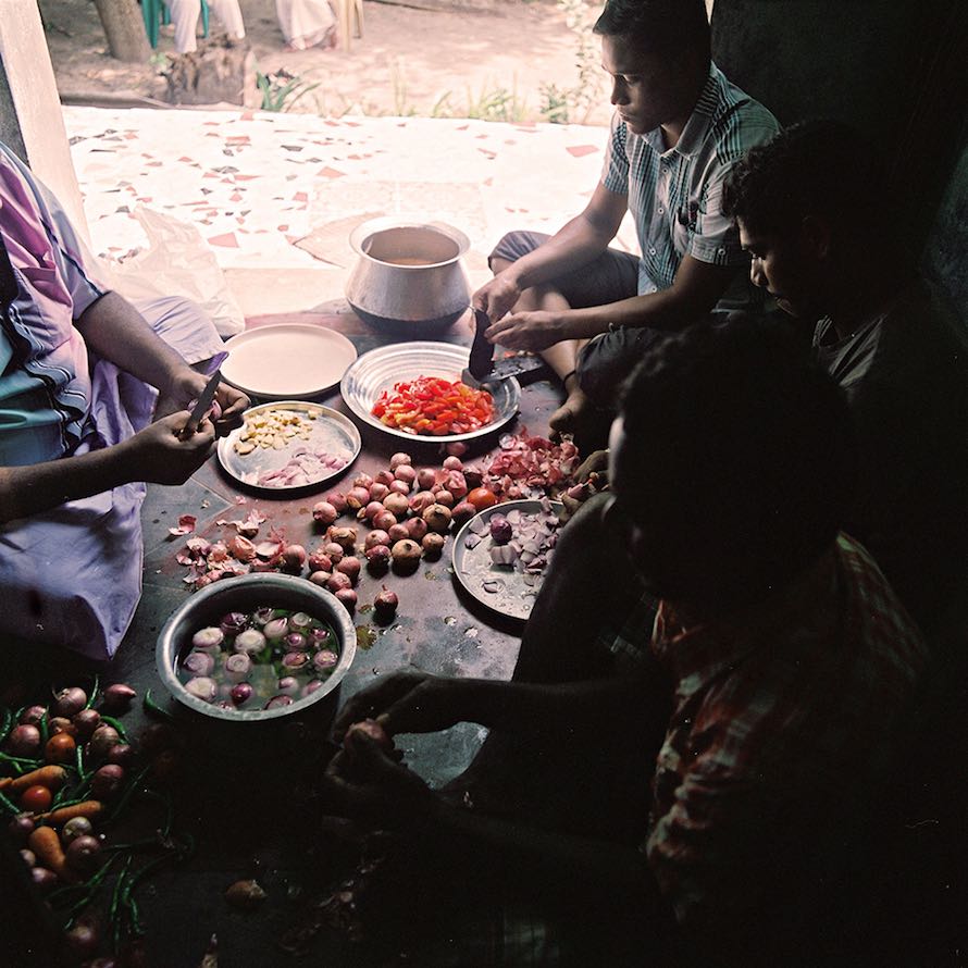 A group of people, including several kothis, prepares food at Sivagami’s house. For many kothis who live with their families, being able to prepare and serve food—considered to be “women’s work”—is a way for them to express part of their female identity. November, 2013.