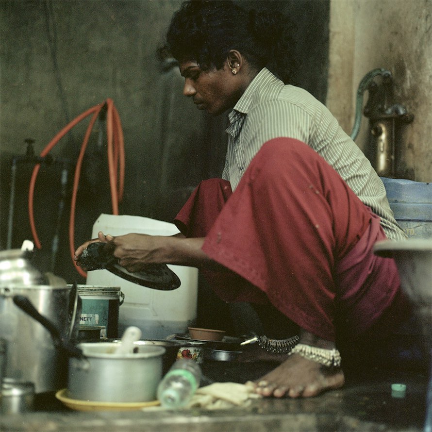 Chitra does dishes in her home outside of Cuddalore. September 2014.