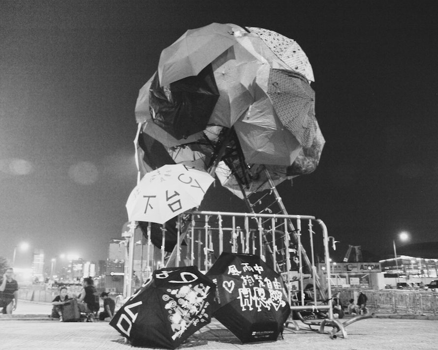 An assemblage of umbrellas sits quietly in Admiralty in the middle of a roundabout. The name 