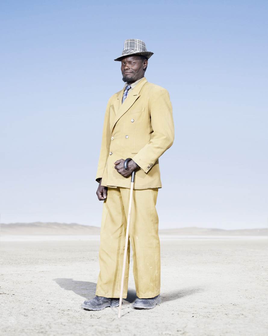 “Herero Man in Yellow Suit” (2012) © Jim Naughten, Image courtesy of Klompching Gallery, New York City