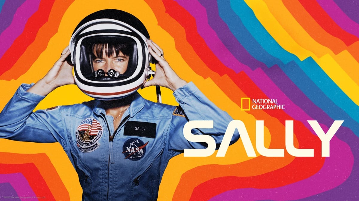Key art for the “Sally” documentary from National Geographic, showing Sally Ride in an astronaut jumpsuit putting a helmet on, with rainbow lines emanating out from her.