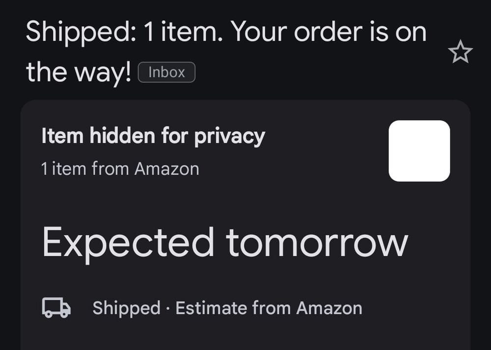 A screenshot of a shipping notification from Amazon, where it says “item hidden for privacy” and the cover is shown as an empty white box.