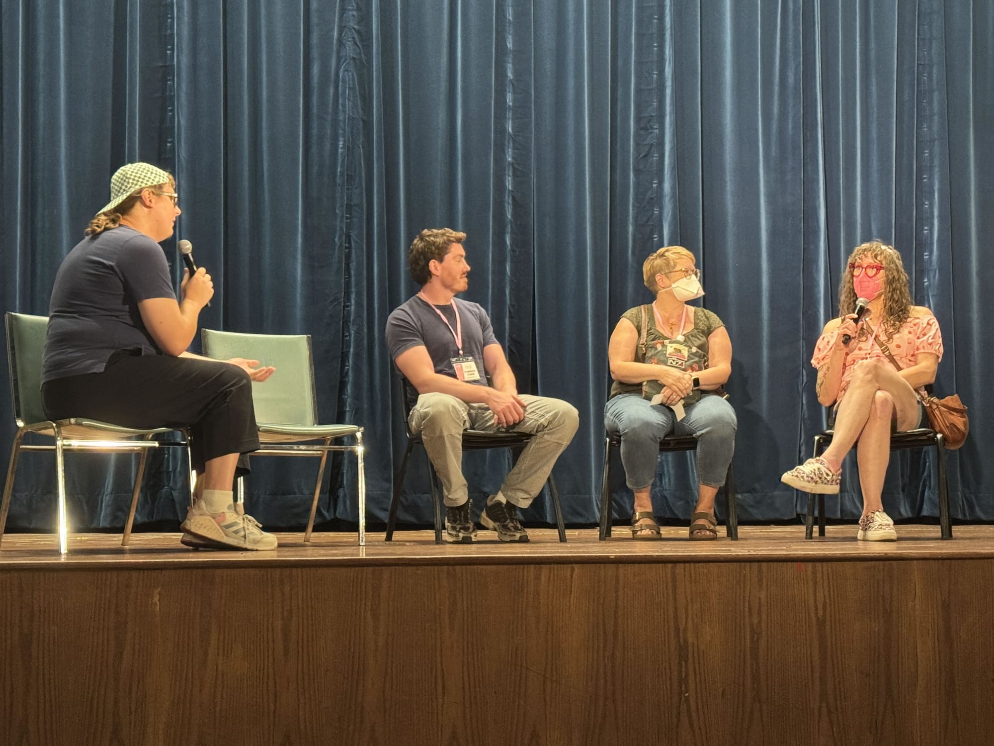 Susan and Tilly seated on stage, talking with another director and panel host from the festival