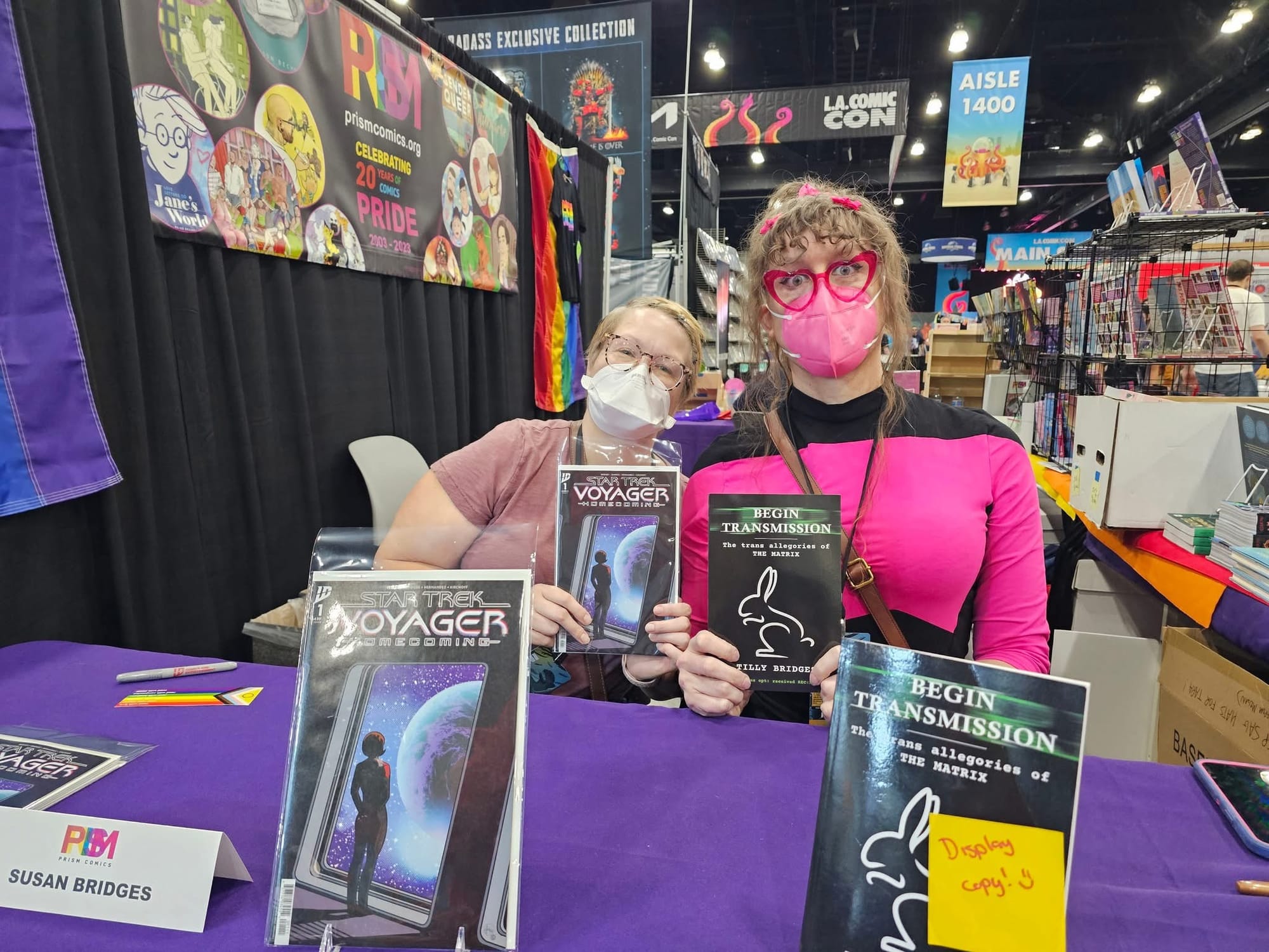 The two of us signing at the PRSIM booth at LACC, holding up copies of Begin Transmission and Star Trek Voyager: Homecoming issue 1