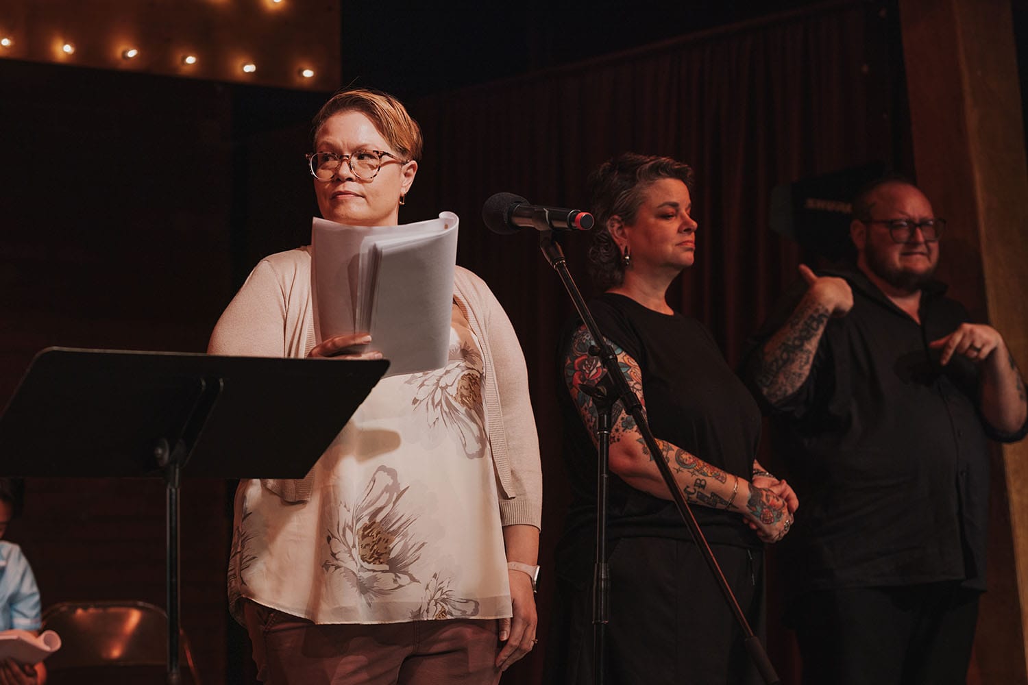 Susan shooting a glare sideways, as our ASL interpreters stand behind her