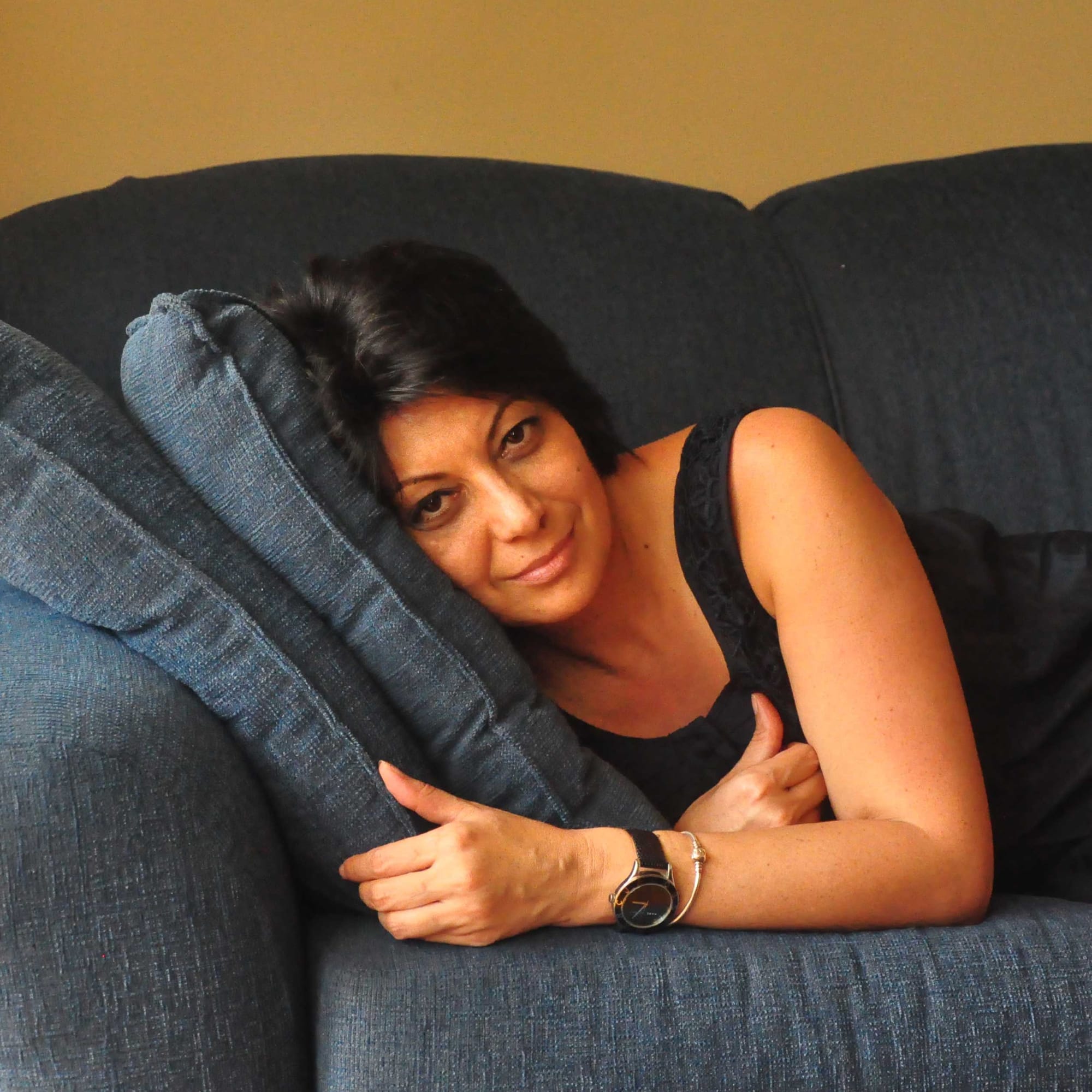 Sarah relaxing on a blue couch