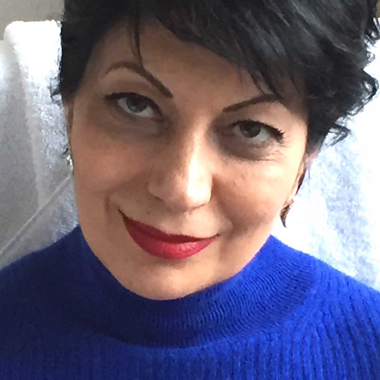 Close portrait of Sarah in a blue sweater