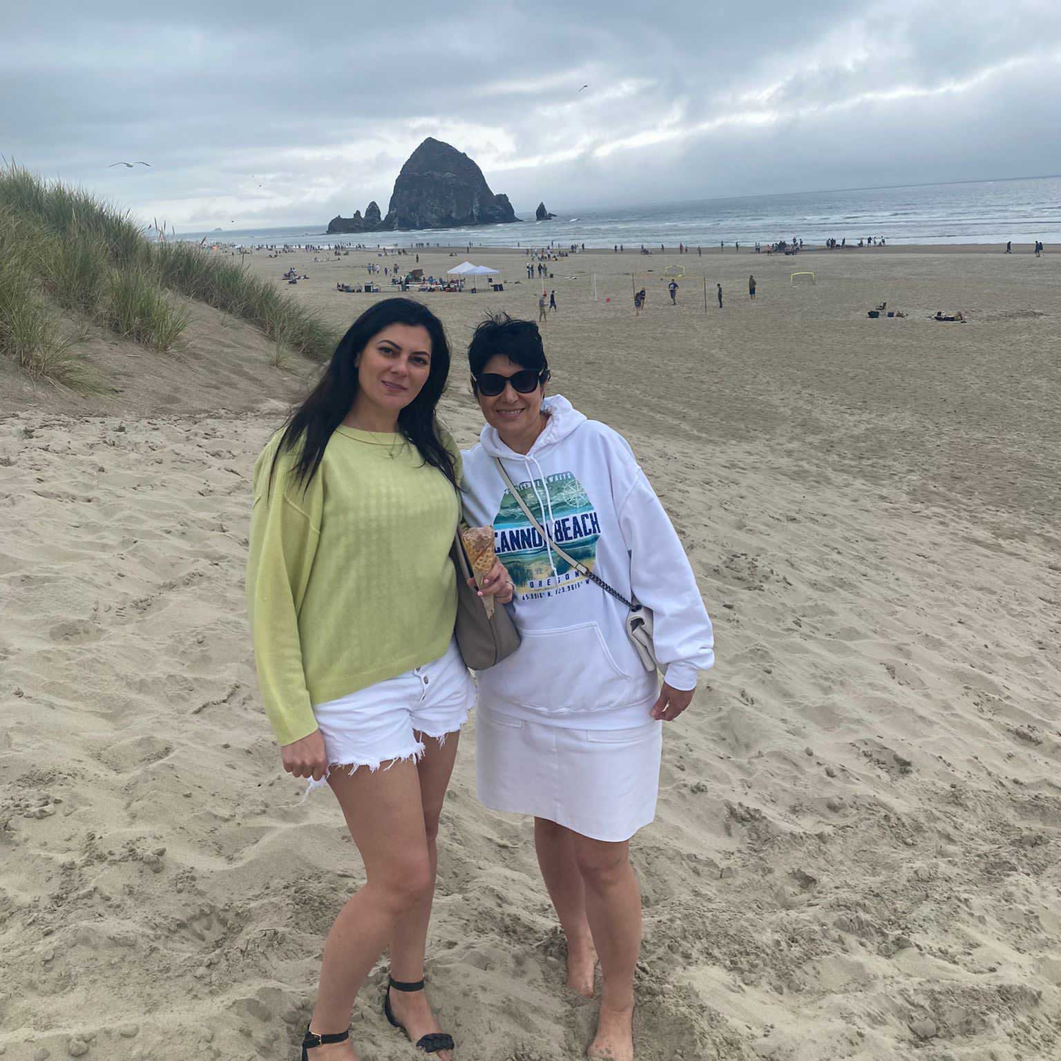 Sarah standing with a companion on a beach