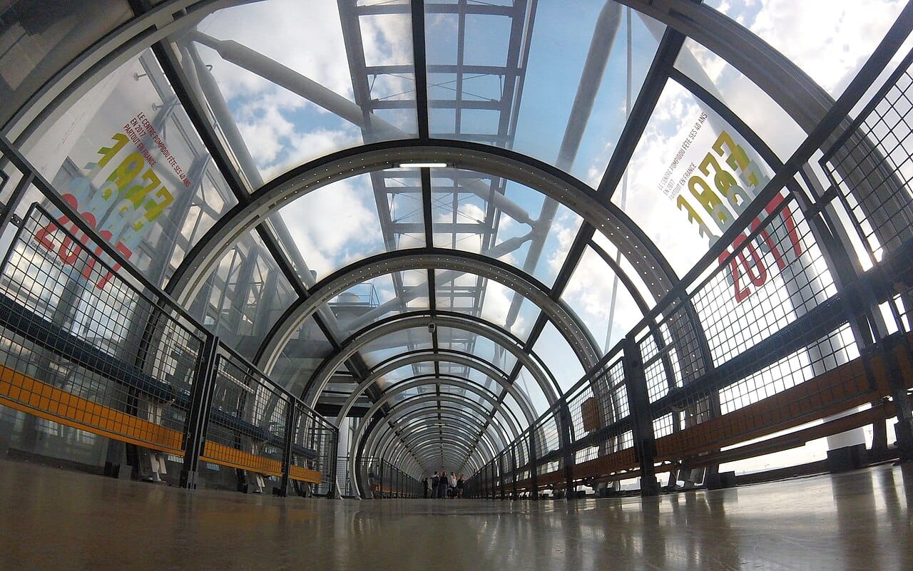 Detail of the Centre Pompidou's exterior, highlighting the color-coded pipes and diagonal escalator tube.