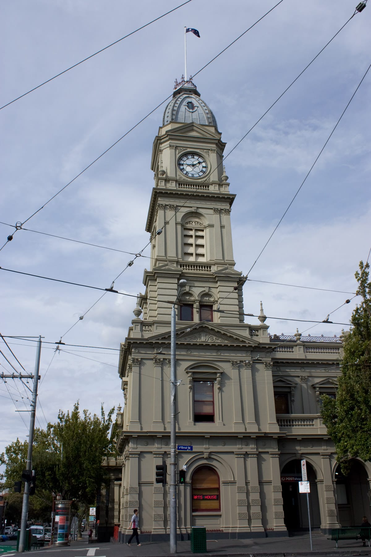 The classical Victorian architecture of the North Melbourne Town Hall, featuring ornate columns and a clock tower.